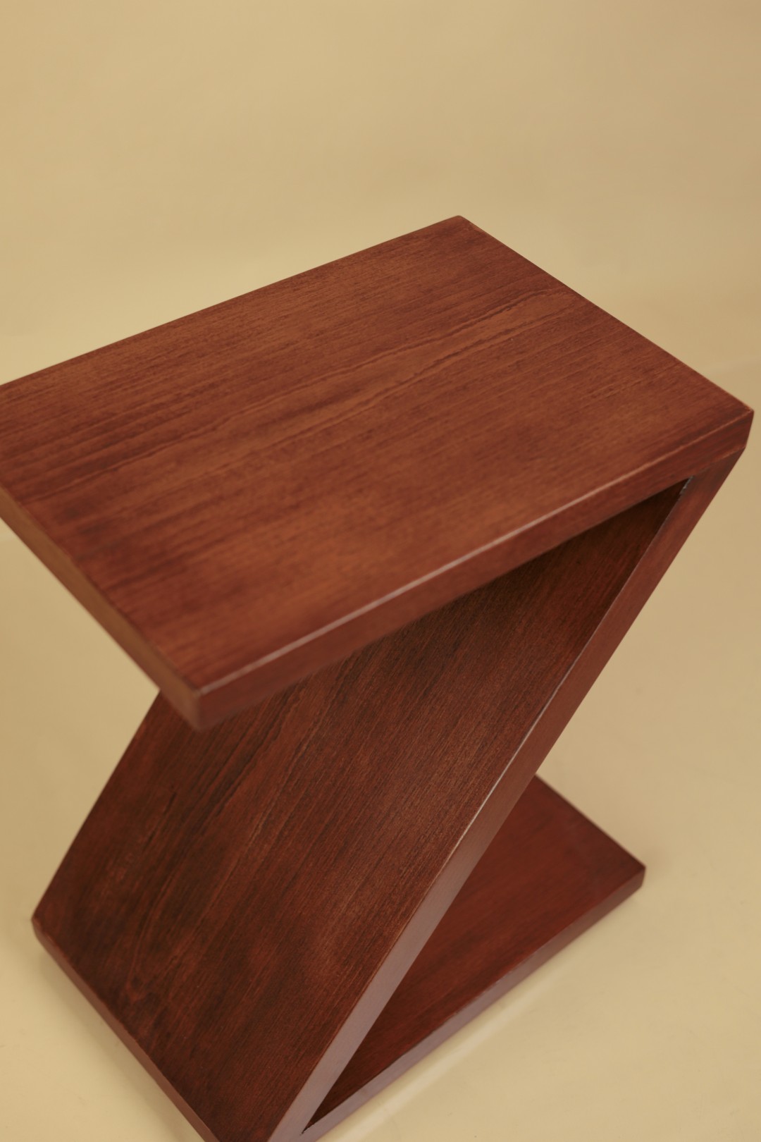 Z side table in mahogany, a cantilevered zigzag form